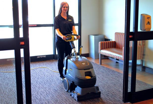 Cleaning carpets with Armada Carpet Extractor in entryway