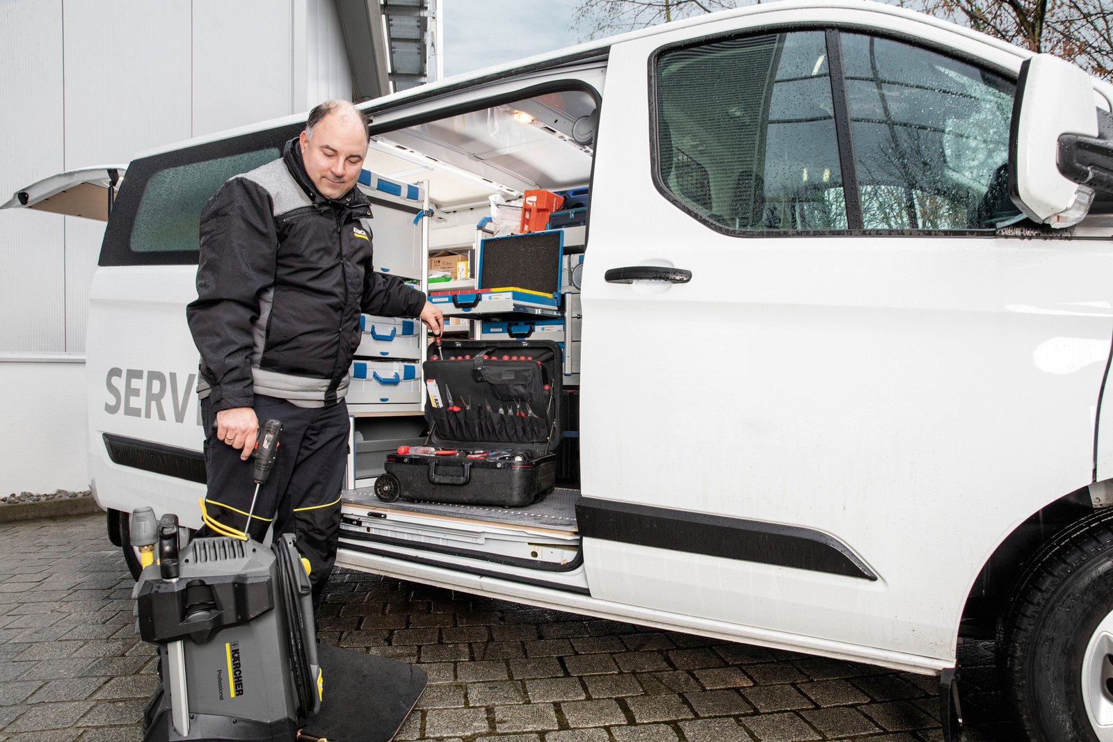 Service-Mitarbeiter vor einem Auto Kärcher Service-Mitarbeiter vor einem Auto