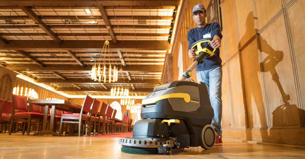 Cleaning the floor of King's Hall Man cleans the wooden floor in King's Hall of Heidelberg Castle with a Kärcher scrubber drier