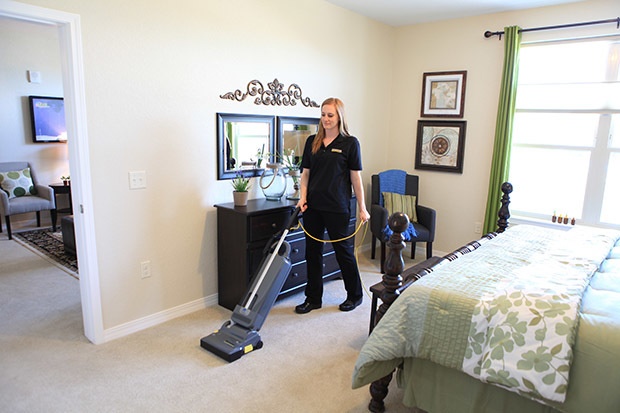 Vacuuming resident's room with Windsor Karcher Group Sensor S2 HEPA vacuum