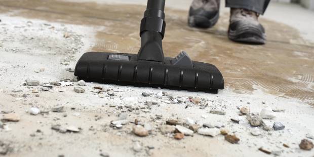 Vacuuming up construction debris with a Karcher wet dry vac