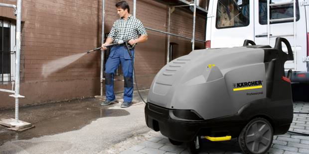 Pressure washing exterior wall with a Karcher pressure washer