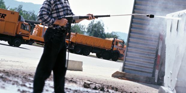 Cleaning construction equipment with Karcher pressure washer