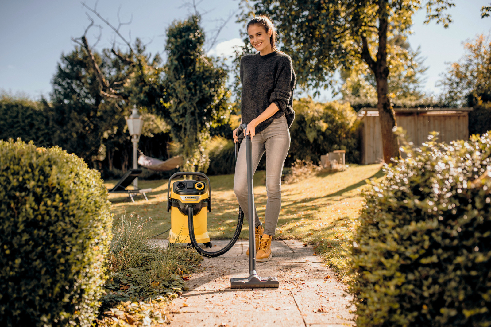 Person cleans garden path with wet and dry vacuum cleaner Wet and dry vacuum cleaners, floor nozzle