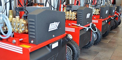 Preserves your Equipment Investment A line of Hotsy pressure washers on a Hotsy dealer's showroom floor