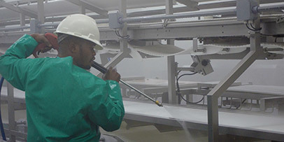 Environmentally Friendly A worker pressure washes to sterilize equipment