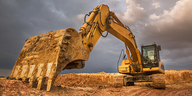 Construction Industry An excavator sits in a construction area.