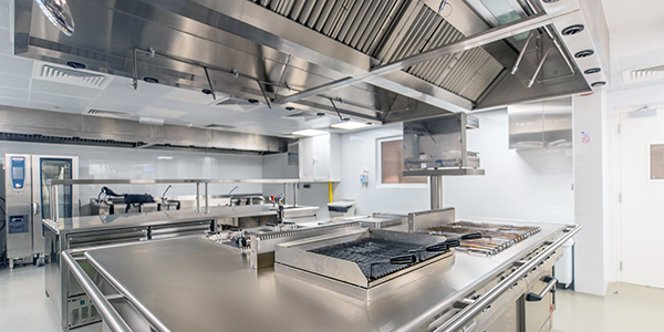 Restaurants, Kitchens & Catering A spotless commercial kitchen is shown with stainless steel counters and equipment.