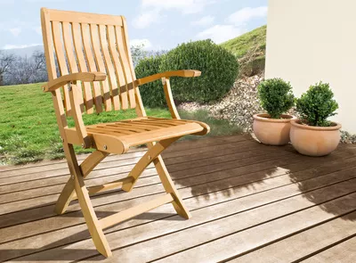 Μια καφέ ξύλινη καρέκλα κήπου σε μια αυλή
