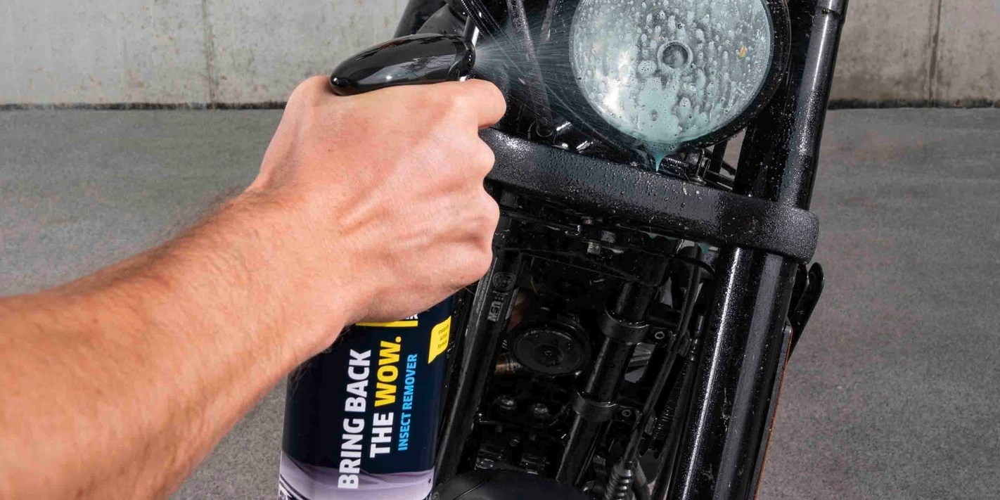 Kärcher insect remover is sprayed onto the motorcycle’s headlight