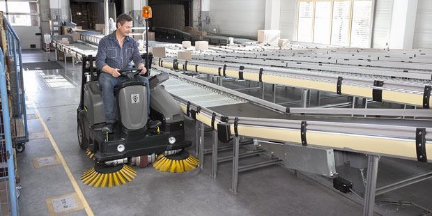 Floor Sweeper Rentals A worker uses a Kärcher industrial sweeper to clean warehouse floors.