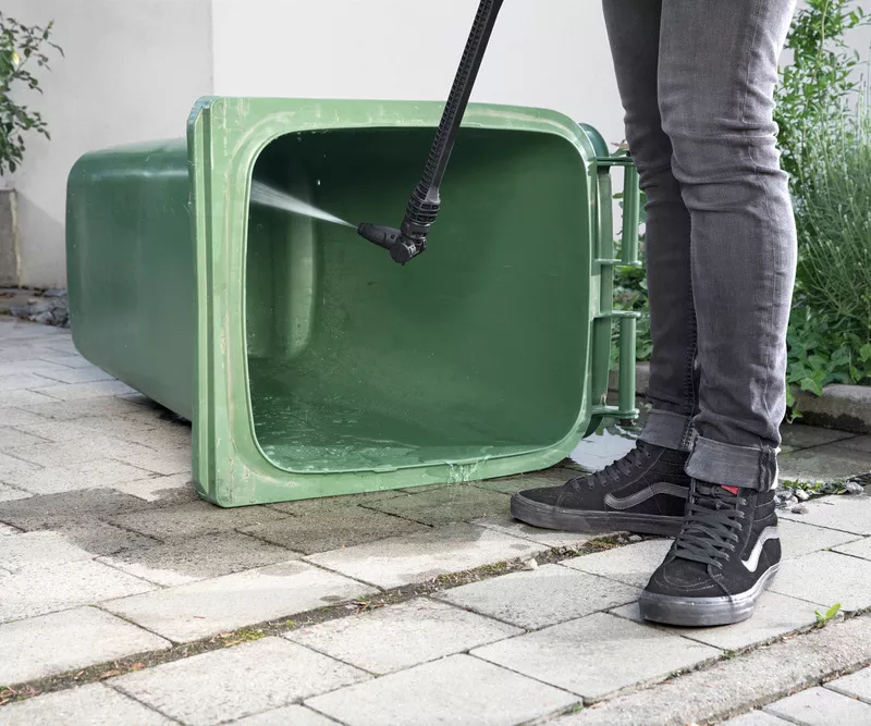 A bin is washed out with a Kärcher medium pressure washer