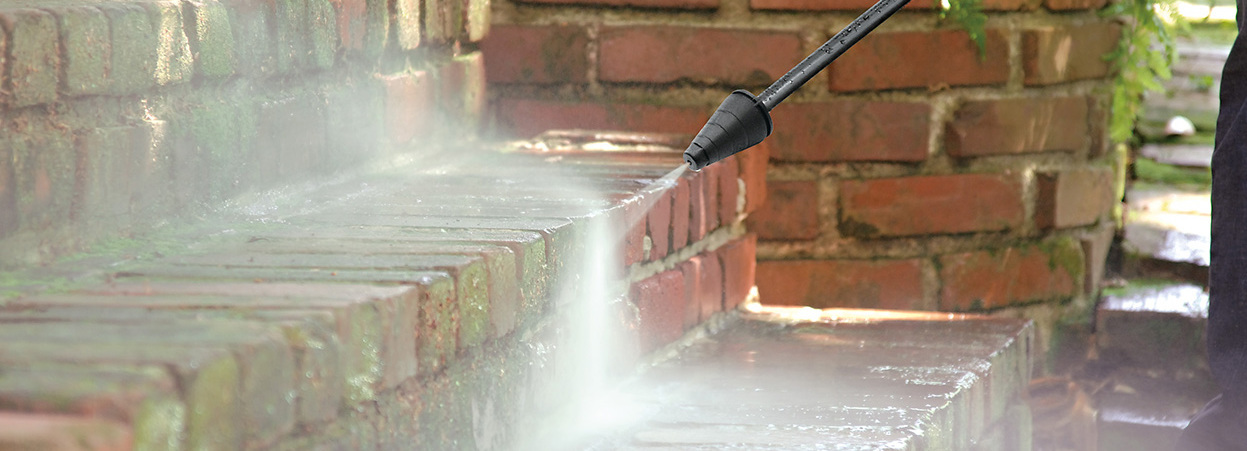 Cleaning mossy pavement using pressure washer
