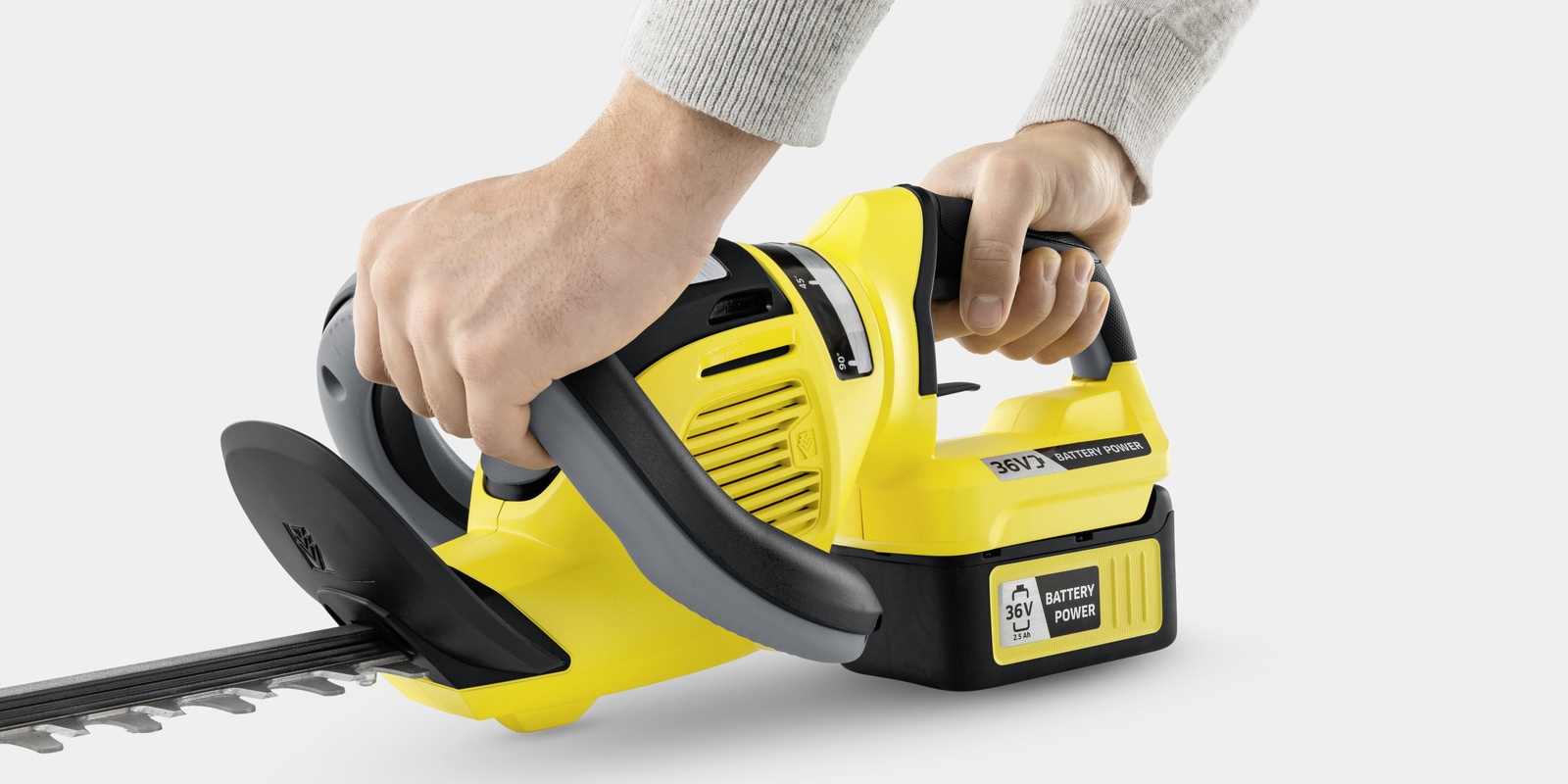 2-hand safety switch 2 hands hold a Kärcher battery hedge trimmer