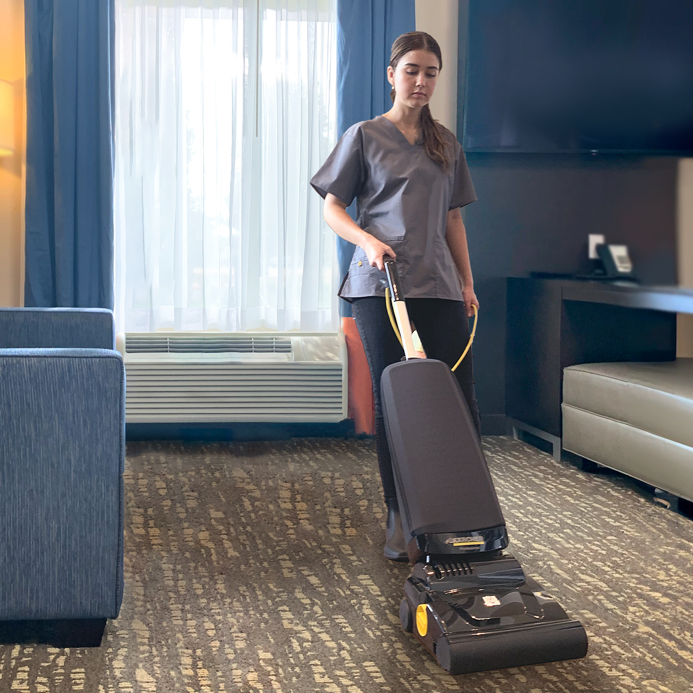 Vacuuming hotel rooms with Ranger Worker vacuums a hotel room