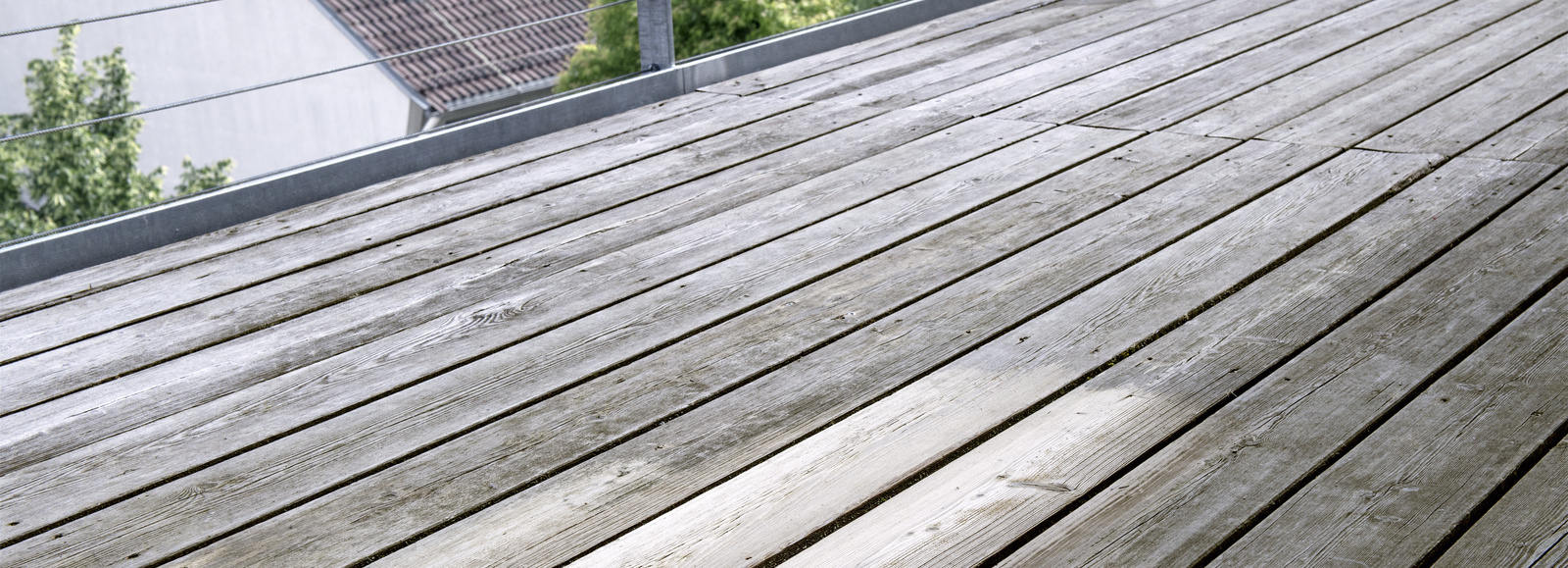 Dégriser une terrasse en bois Une terrasse en bois avec des nuances de gris clair et de gris foncé