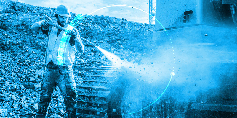 Illustration of a man pressure washing construction equipment