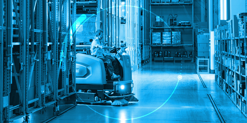 Illustration of a worker cleaning a factory floor with a professional scrubber