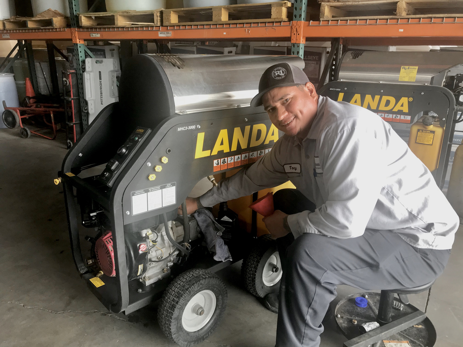 Scheduled Maintenance A service technician works on a Landa MHC hot water pressure washer