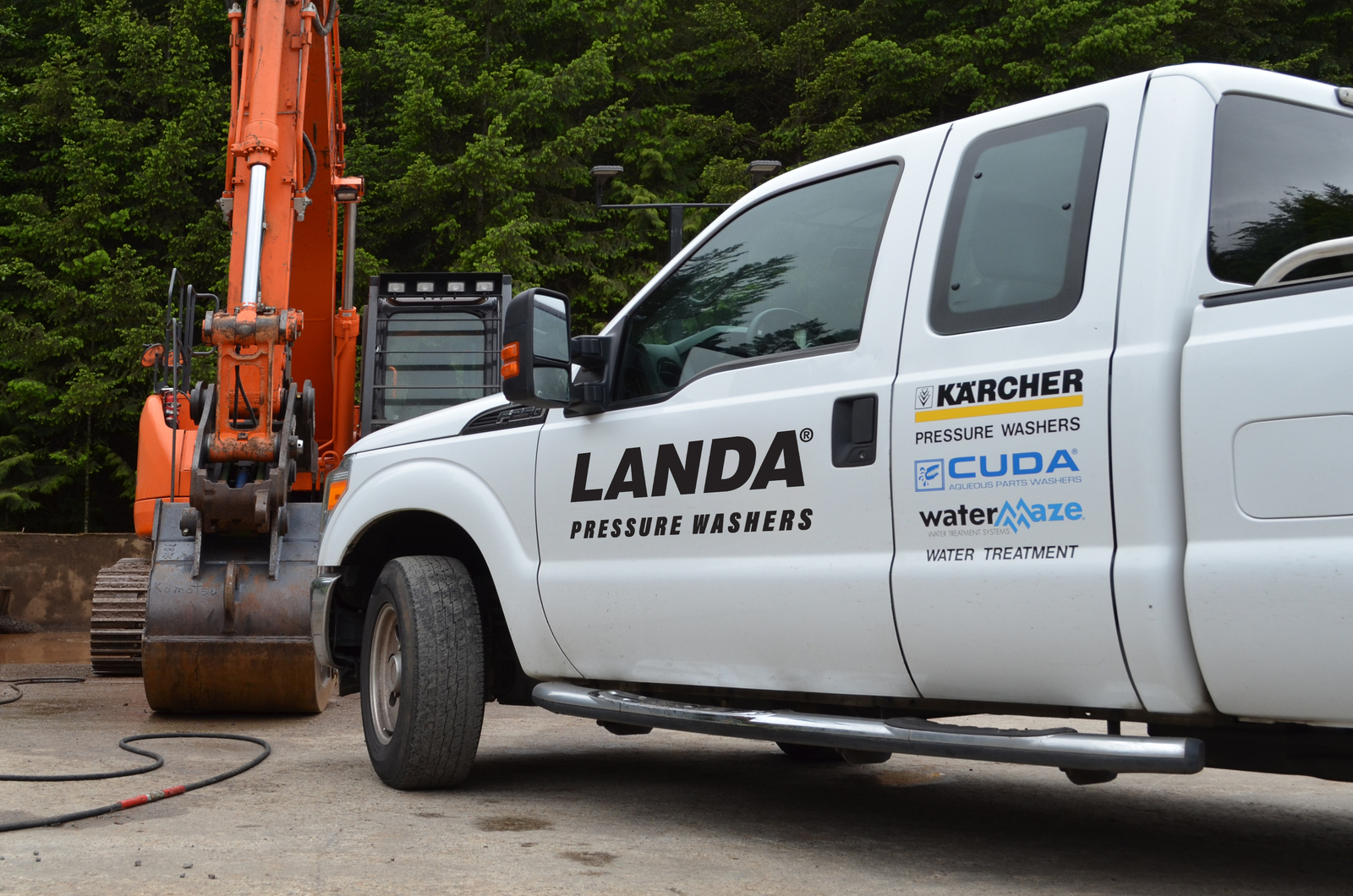 Repair on Location or at Your Local Dealer A Landa service truck with construction equipment in the background