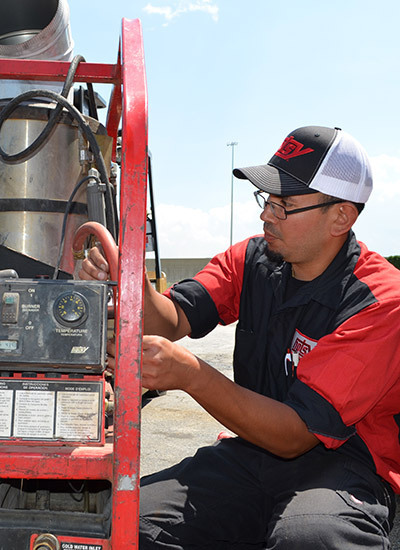 Hotsy's 24-Point Tune-Up A technician works in the field to service a Hotsy pressure washer