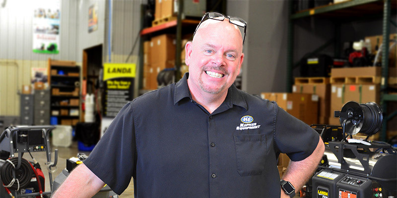 Photo of a Landa pressure washer dealer in his showroom