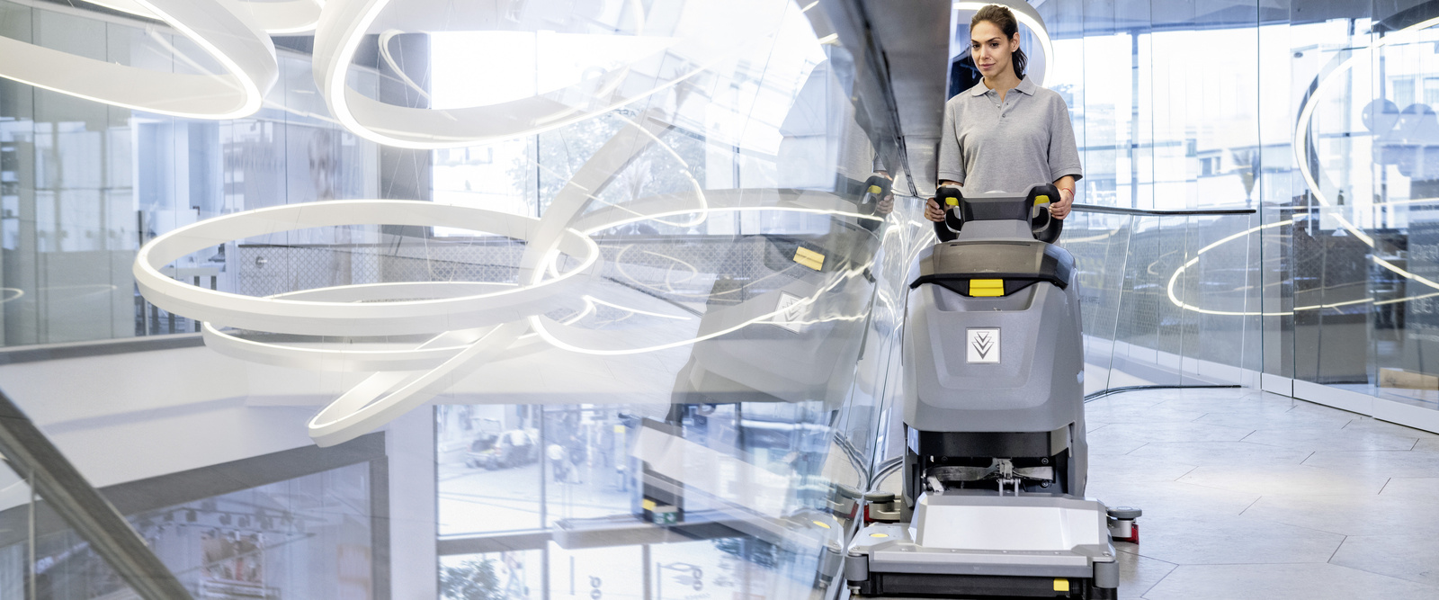Building cleaning with a scrubber dryer A person cleaning the floor with a Kärcher scrubber dryer