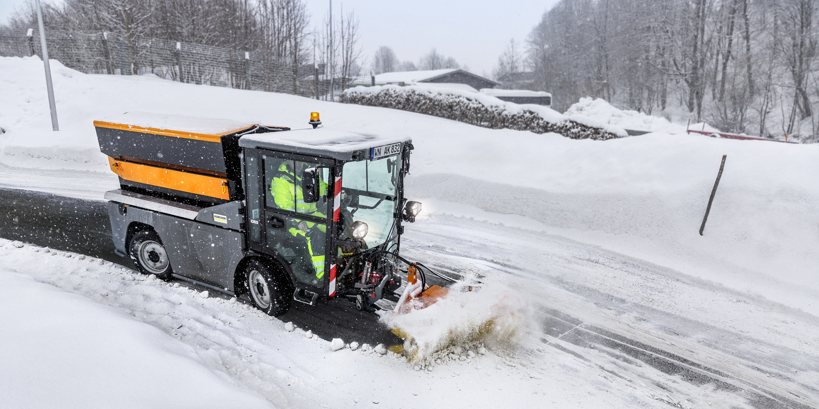 Sweeping snow Front sweeper from Kärcher clearing a snow-covered street