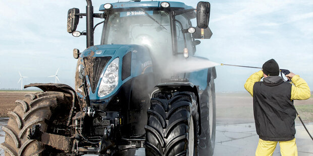 Kärcher Cold Water Gas Pressure Washers A worker cleans a tractor using a Kärcher Cold Water Gas Pressure Washer