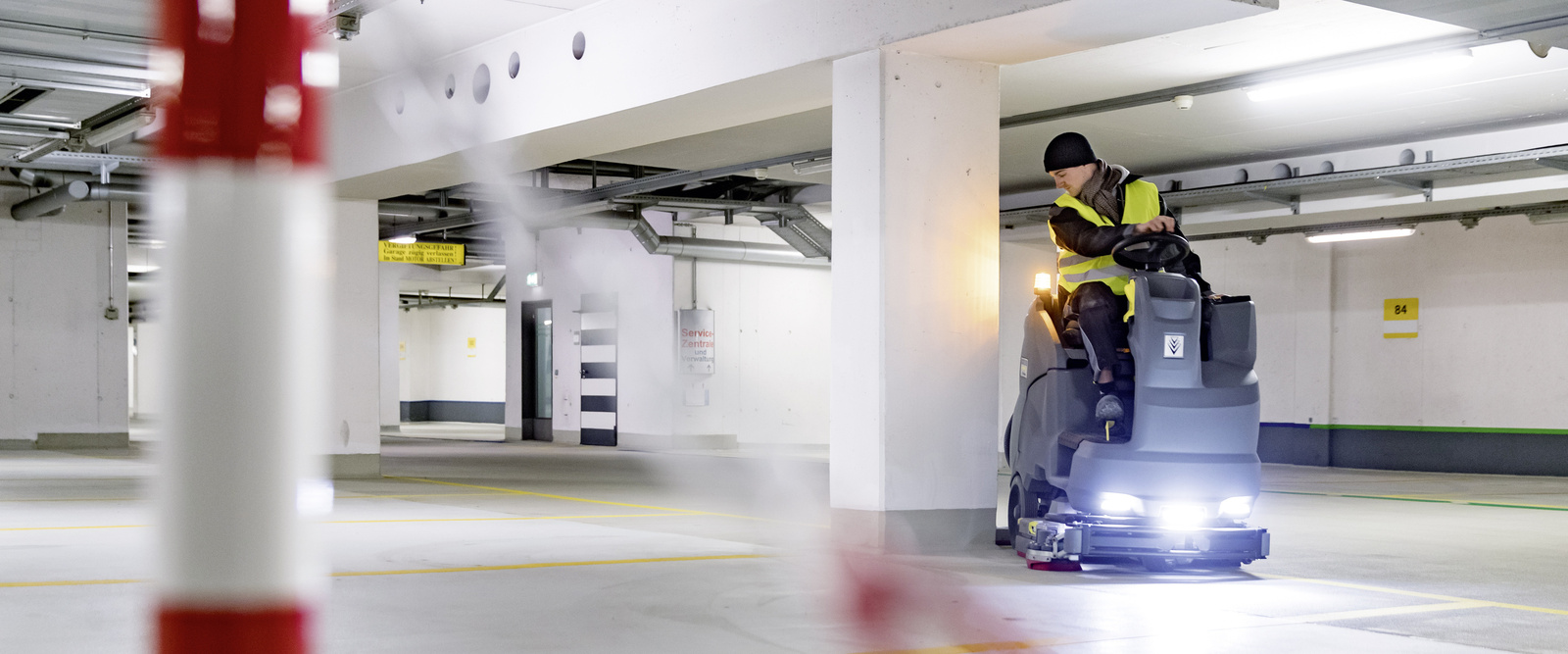 Vacuum sweeper in use a person operating a vacuum sweeper in a car park