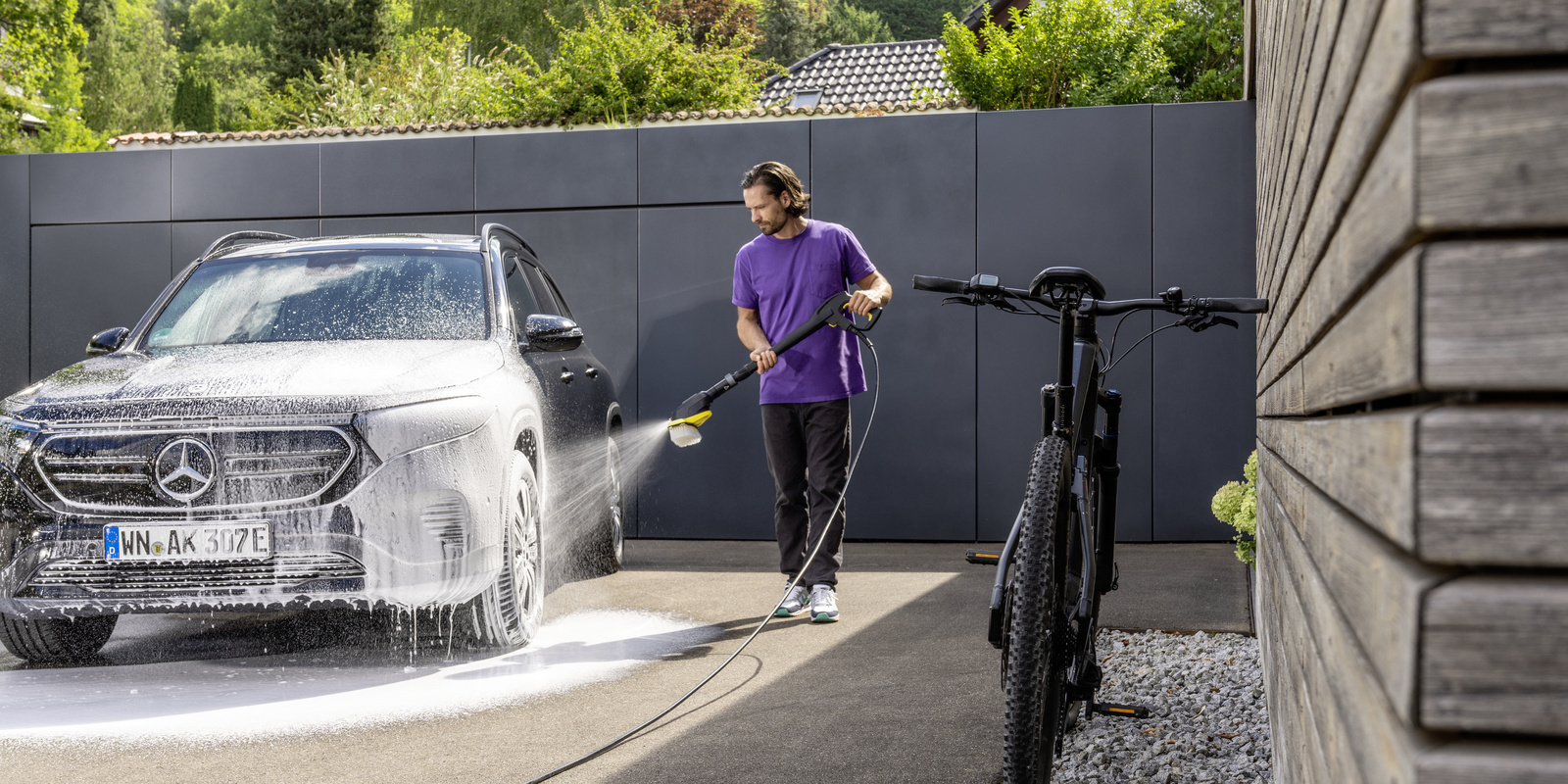 Car washing A man is washing his car