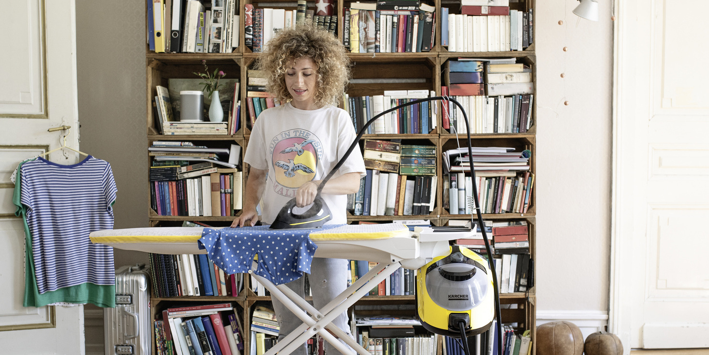 Woman ironing with Kärcher steam cleaner iron