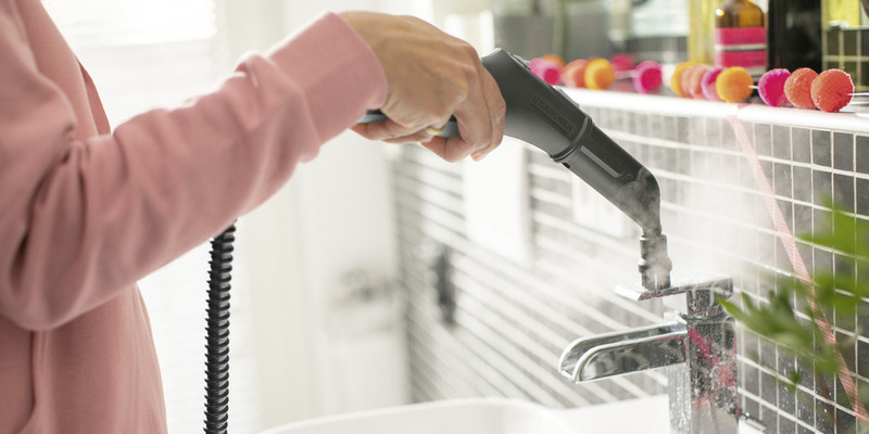 Cleaning of water tap with with steam cleaner brush