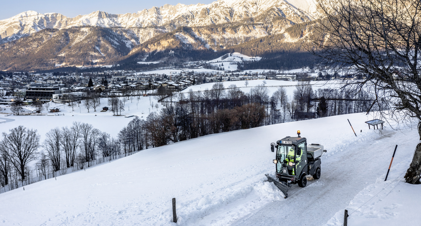 Clearing a cycle path A person clearing a cycle path in winter with a Kärcher clearing device