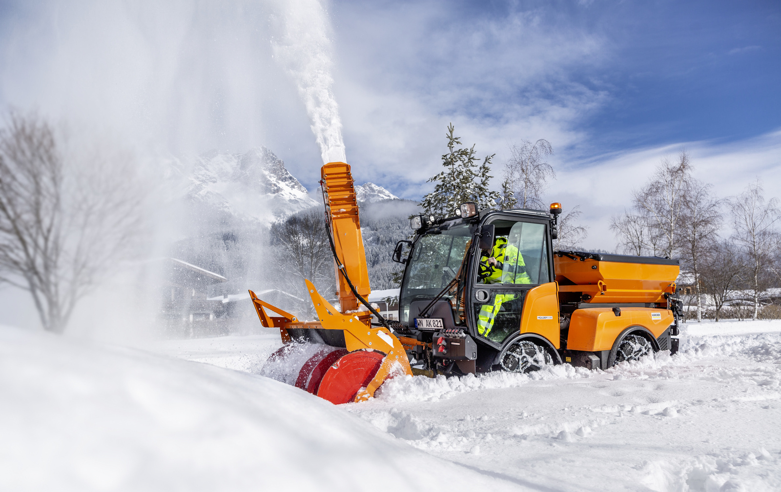 Snow thrower A person operating a Kärcher snow thrower in deep snow