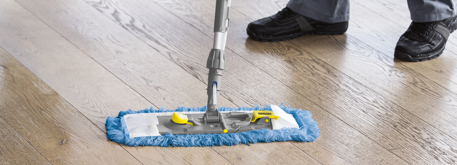Mop system in use A person mopping a wooden floor