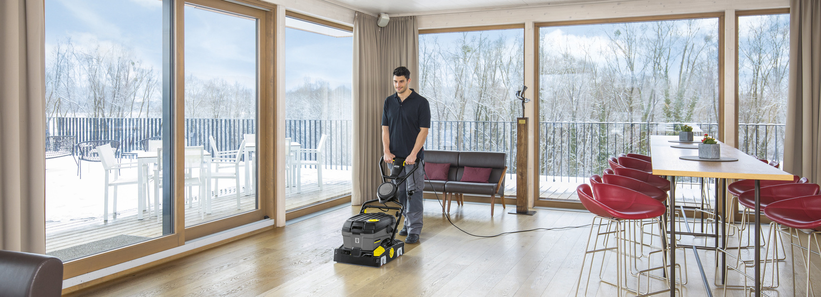 Scrubber dryer in use A man cleaning the floor with a Kärcher scrubber dryer