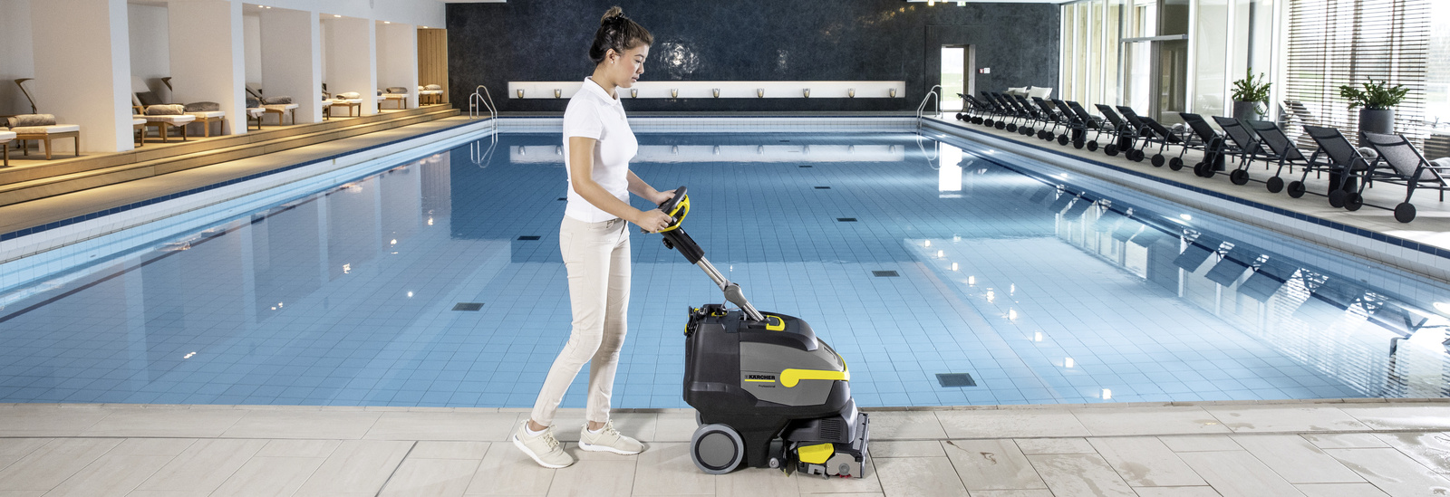 Scrubber dryer A person cleans the tiles in the spa area with the help of a scrubber dryer