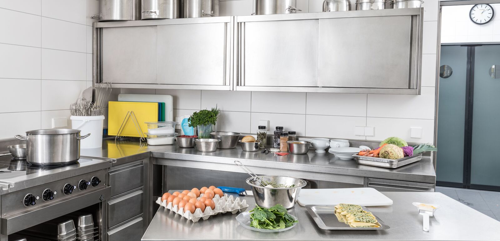 A commercial kitchen with a variety of food and cooking utensils