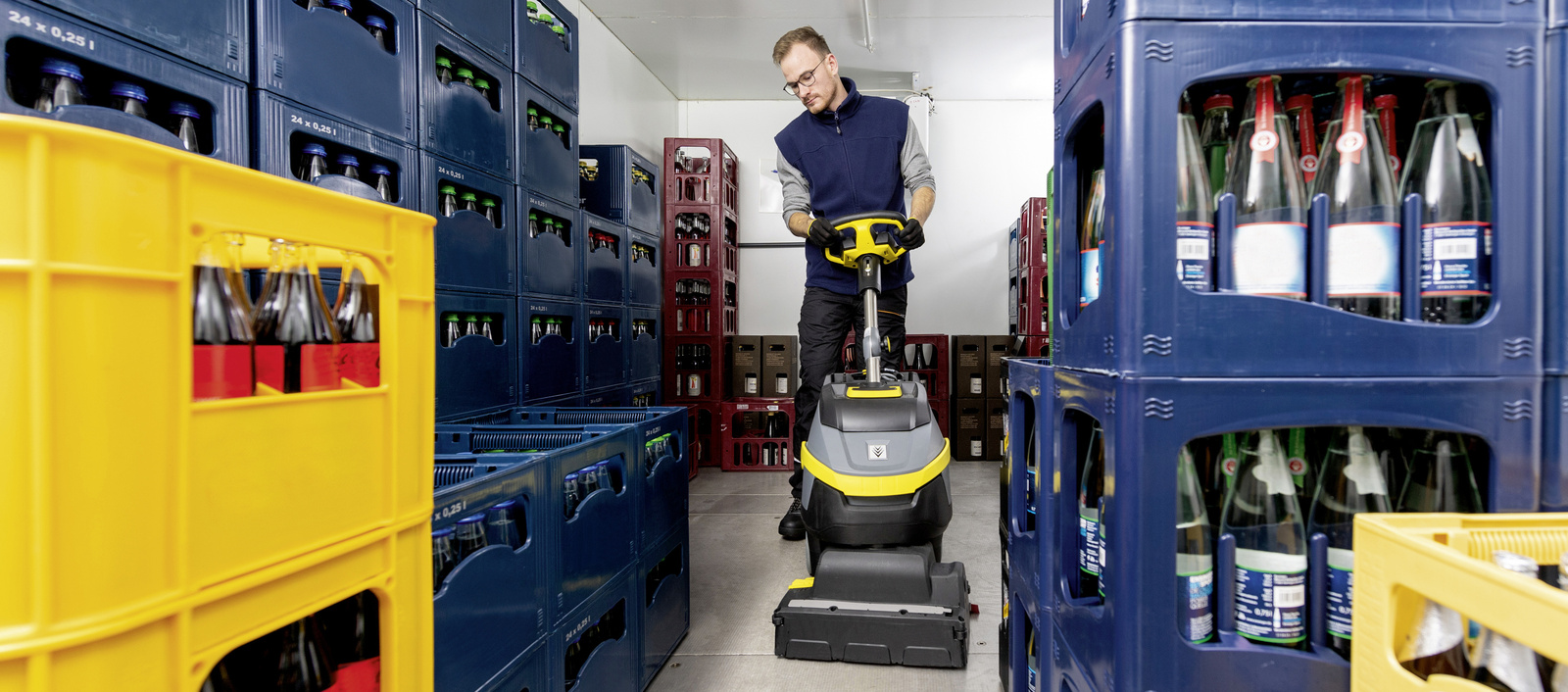 Cleaning a cold store A person operating a scrubber dryer in a cold room