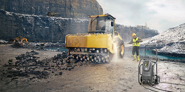 Unlimited Run-Time A worker cleans industrial equipment with an electric pressure washer