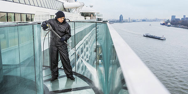 Versatility A worker uses a battery powered pressure washer to clean the loading deck of a ship