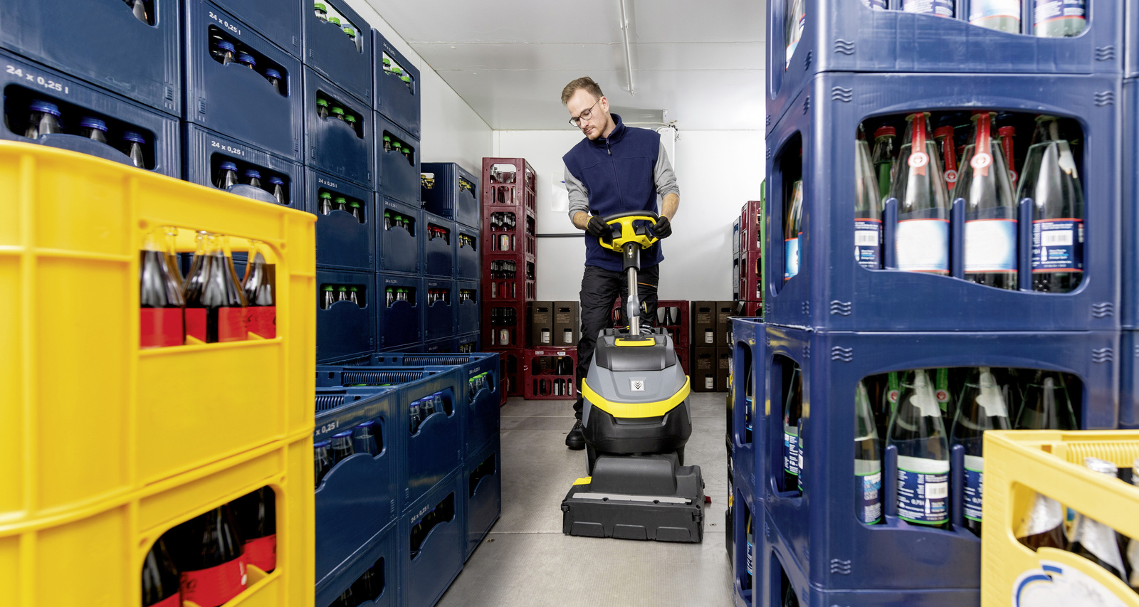 Scrubber dryer A person operates a scrubber-dryer in the cold room