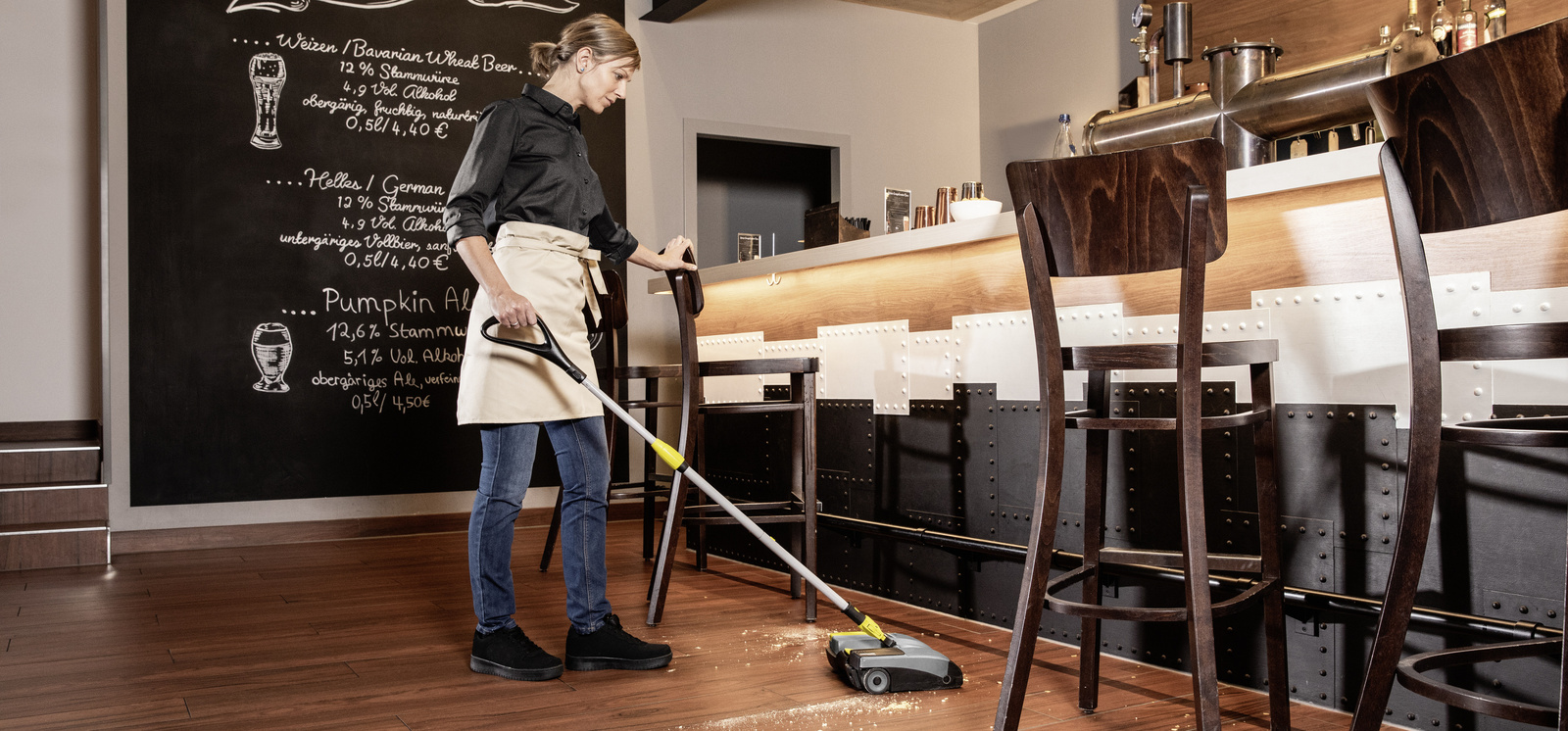 Electric broom in use A person cleaning the floor with an electric broom