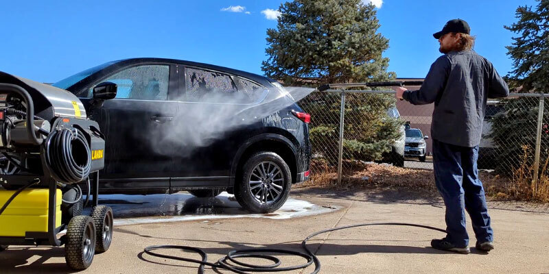 Request a free demo A worker pressure washes his car with a Landa pressure washer