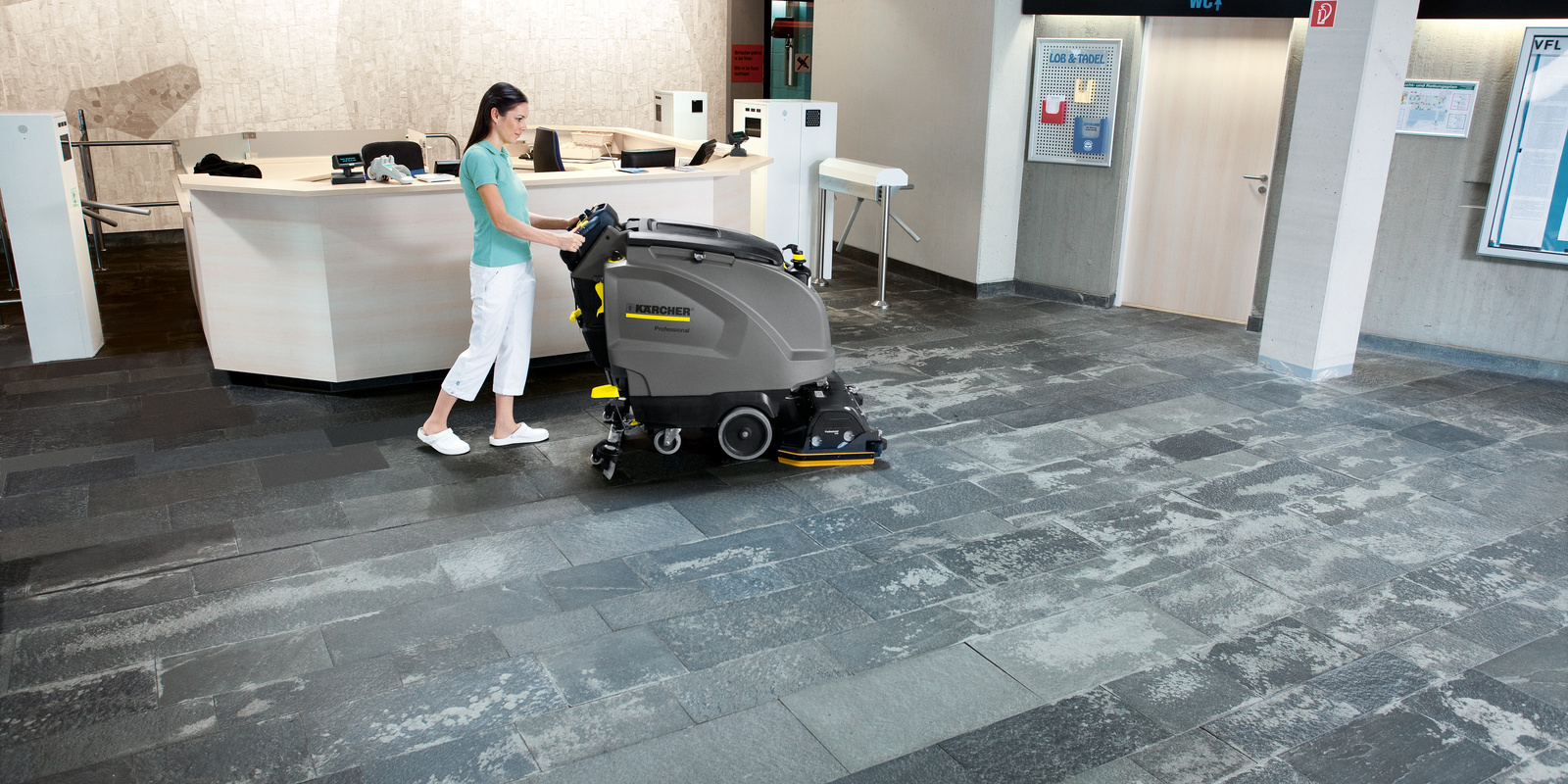 Scrubber dryer in use A person cleaning a polished stone floor with a scrubber dryer