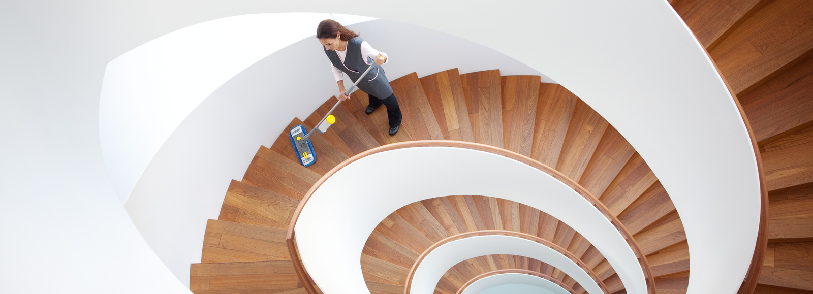 Cleaning a stairwell A person cleaning a stairwell with a mop