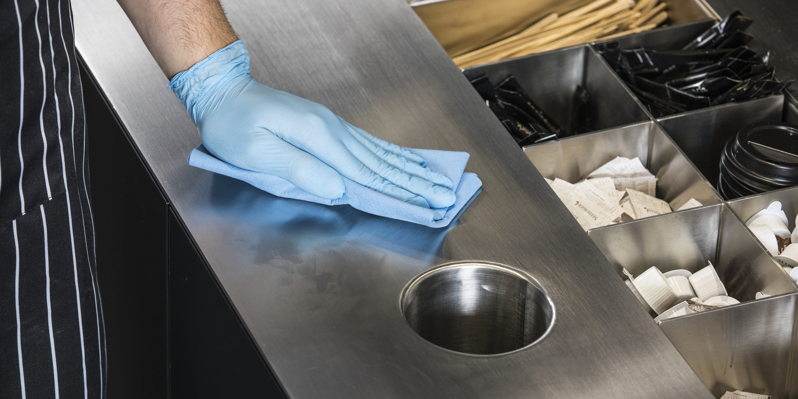 Surface cleaning A person cleaning a surface with a microfiber cloth
