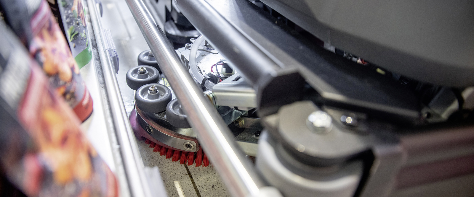 Wide mop in use A shelf being cleaned with a wide mop