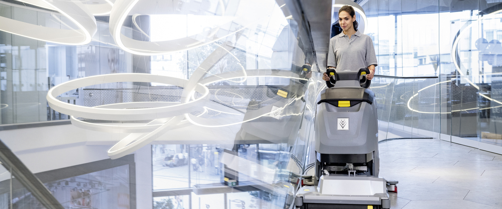 Vacuum sweeper in use A person cleaning a granite floor with a vacuum sweeper